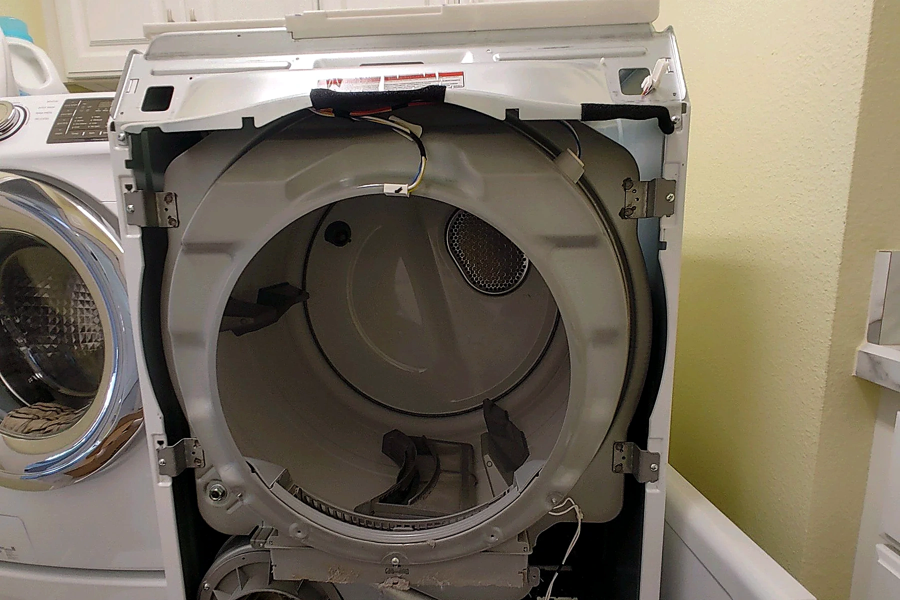 Illustrative technician examining a washing machine